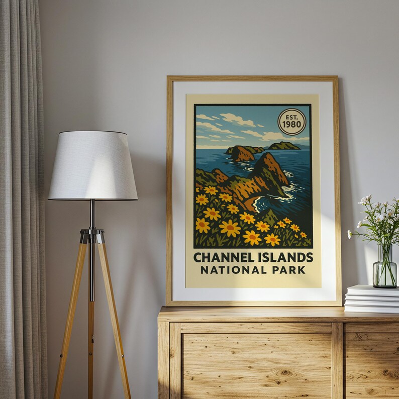 May include: A framed print with a retro illustration of Channel Islands National Park. The artwork shows a coastal scene with cliffs, ocean, and yellow flowers. The text "CHANNEL ISLANDS NATIONAL PARK" is below the image, with "EST. 1980" in a circle.