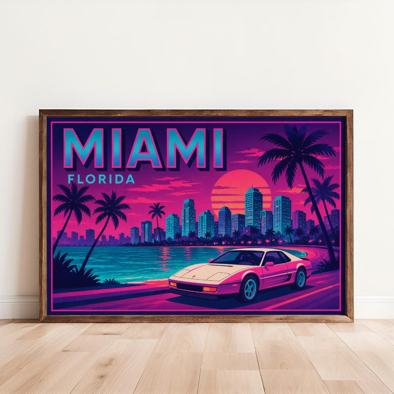 May include: A framed art print featuring a retro Miami, Florida scene. The artwork showcases a pink sports car driving along a coastal road, palm trees, and a cityscape under a vibrant sunset. The word "MIAMI" is displayed at the top.