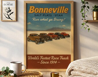 May include: A framed vintage-style poster with the text "Bonneville" and "World's Fastest Race Track - Since 1914-". The poster features classic race cars on a salt flat, with a blue sky background. A small framed art piece and a coffee mug are also visible.