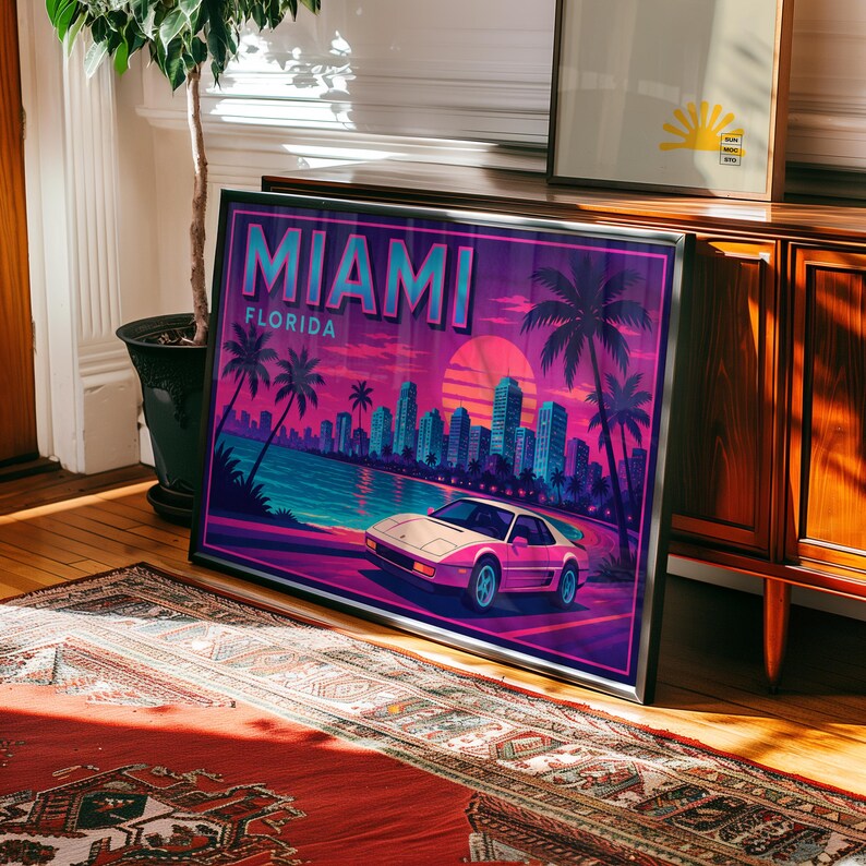 May include: Framed art print featuring a retro Miami, Florida design. The artwork showcases a pink sports car, palm trees, a cityscape, and the text "MIAMI FLORIDA" in a vibrant color palette of pink, purple, and teal.