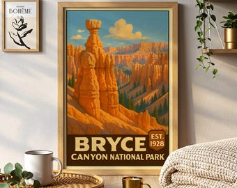 May include: A framed print of Bryce Canyon National Park. The artwork features a landscape of orange rock formations under a blue sky with clouds. The print includes the text "BRYCE CANYON NATIONAL PARK" and "EST. 1928".