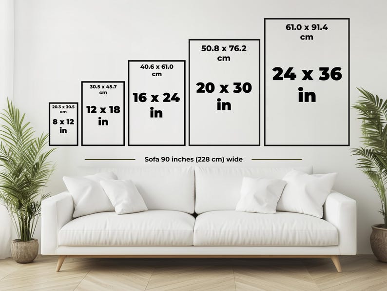 May include: Five framed art prints of varying sizes, from 8 x 12 inches to 24 x 36 inches, are displayed above a white sofa. The dimensions in inches and centimeters are clearly labeled on each frame. The sofa is 90 inches wide.