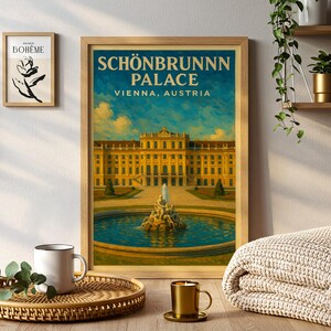 May include: A framed print of Sch&ouml;nbrunn Palace in Vienna, Austria. The artwork features a detailed illustration of the palace with a blue sky background. The print is in a wooden frame and is displayed on a wooden surface.
