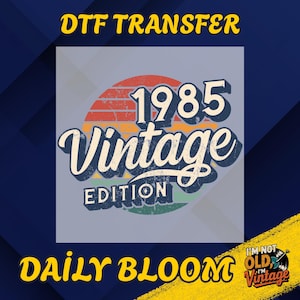 May include: DTF TRANSFER graphic with the text "1985 Vintage Edition" in a retro design. The design features a sunset-style background with red, orange, and green stripes. The words "Daily Bloom" and "I'm not old I'm vintage" are also present.