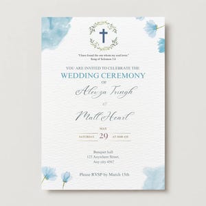 May include: A wedding invitation with a watercolor design. The invitation features a cross within a wreath, floral accents, and text in a script font. The invitation includes the names of the couple, date, time, and location.
