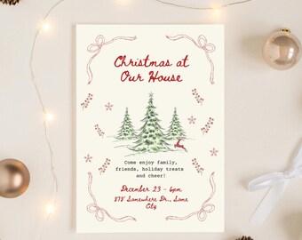 May include: A cream-colored Christmas invitation with red text and illustrations. The text reads "Christmas at Our House" with a drawing of three Christmas trees and a reindeer. The invitation includes the date and time of the event.