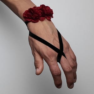 May include: A white ceramic mug with a black handle and the text "But First, Coffee" in a bold, black font. The mug is sitting on a wooden surface. The mug is approximately 4 inches tall.