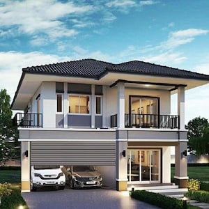 May include: A two-story house with a dark tiled roof, white and gray exterior walls, and a balcony with a black railing. The ground floor features a garage with a horizontal shutter door, a glass sliding door entrance, and two parked cars.