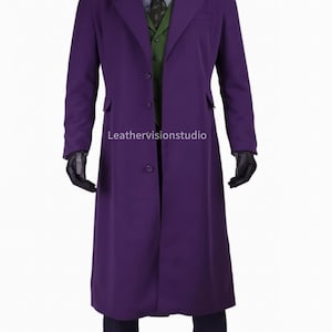 May include: A long, purple overcoat with a notched lapel, worn over a green vest, patterned shirt, and tie. The coat has a single-button closure and two front pockets. Black gloves are worn. The text "Leathervisionstudio" is visible.