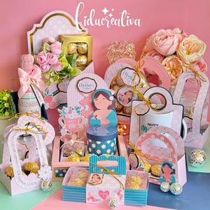 May include: A collection of gift boxes and decorative items in shades of pink, blue, and gold, with floral and heart motifs. The boxes contain chocolates and other treats, with the text "Mother's Day" visible on some items.