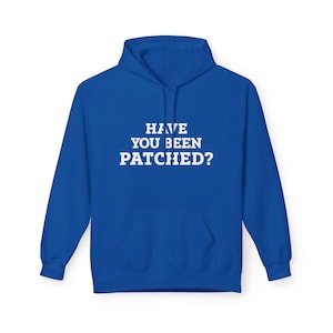May include: A royal blue hoodie with a front pocket and a hood. The white text "HAVE YOU BEEN PATCHED?" is centered on the chest. The hoodie is made of a soft material.