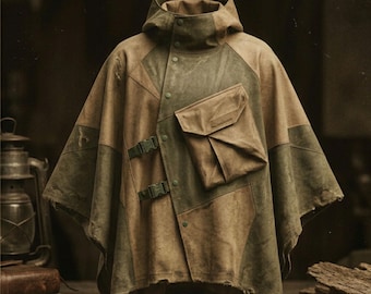 May include: A hooded poncho in olive green and tan, featuring a color-blocked design with a large front pocket, two side-release buckles, and a snap-button closure. The garment has a distressed, textured finish with frayed edges at the hem.