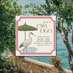 Puede incluir: Invitación de boda con borde rojo y fondo crema. La invitación presenta una grulla bajo una sombrilla verde. El texto incluye "CASA LAGO" y los detalles de la boda.