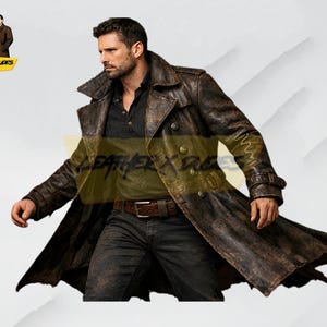 May include: A distressed brown leather trench coat with a double-breasted design. The coat features a wide collar, button closures, and a belt. The model is wearing a black shirt and dark jeans. The logo "LEATHER X DUDES" is visible.