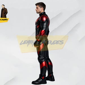 May include: Black and red leather suit with a high collar, featuring red accents on the shoulders, arms, and legs. The suit includes matching boots. The image also shows the Leather x Dudes logo.