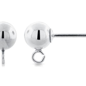 May include: Two silver-colored ball stud earrings. One earring has a post with a small ball at the end, and the other has a loop. The earrings are round and shiny, reflecting the light. The earrings are on a white background.