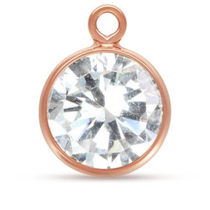 Può includere: Un ciondolo in oro rosa con un cristallo rotondo trasparente e un anello in cima.