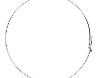 May include: A simple silver bangle bracelet with a hinged clasp.