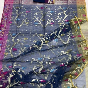 May include: A sheer, navy blue sari with gold floral and tree patterns. The sari has a pink, purple, and gold border. A matching navy blue fabric piece with a gold and black design is included.