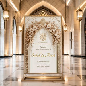 Islamic gold floral Nikah welcome sign displayed on a modern gold floor stand in a luxury venue.