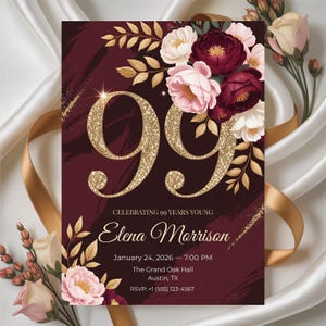May include: Burgundy and gold 99th birthday invitation. The design features large gold glitter numbers, floral accents, and the text "Celebrating 99 Years Young" with event details. The invitation is for Elena Morrison.