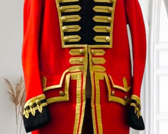 May include: A vibrant red military-style coat with gold trim and black accents. The coat features a high collar, decorative gold buttons, and gold embellishments along the front and sleeves. The sleeves have black cuffs with gold detailing.