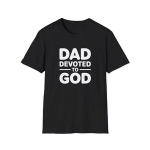 May include: Black t-shirt with the white text "DAD DEVOTED TO GOD". The text is arranged in three lines, with "DAD" at the top, "DEVOTED TO" in the middle, and "GOD" at the bottom. The shirt is a classic crew neck.