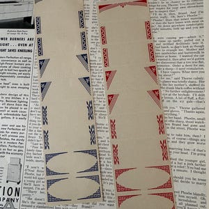 May include: Vintage paper ephemera with repeating red and blue geometric designs. These decorative paper cutouts, with a repeating pattern, are ideal for scrapbooking or crafting projects. The paper is aged and shows signs of wear.