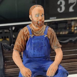 Tim in coveralls resting, unpainted