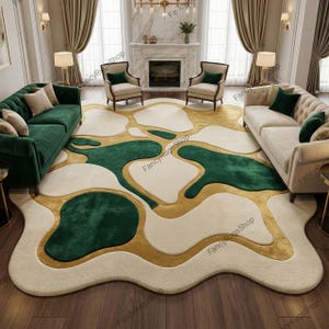 May include: A large, abstract area rug with a cream-colored background, featuring irregular shapes in emerald green and gold. The rug is placed in a living room setting with green and beige sofas, and armchairs.
