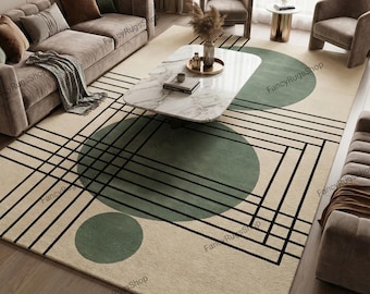 May include: A beige area rug with a geometric design. The rug features large green circles and black lines forming a grid pattern. The rug is in a living room setting with a sofa, chairs, and a marble coffee table.