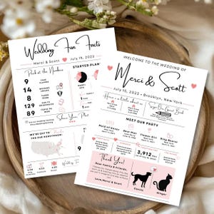 May include: Two white wedding information cards featuring black and pink text and graphics. The cards display "Wedding Fun Facts" and "Welcome to the Wedding of Merci & Scott" with details about the couple, wedding party, and a thank you note.
