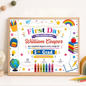 May include: A rectangular certificate in a wooden frame titled First Day, featuring the name William Cooper, 5th Grad, and Congratulations. The design includes colourful illustrations of a backpack, globe, rainbow, books, and crayons on a white background.