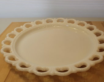 May include: A white milk glass serving plate with a scalloped edge and openwork design.