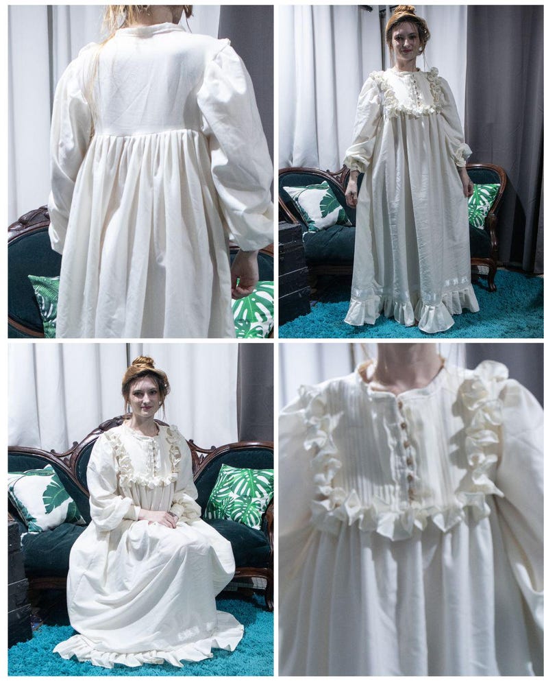 May include: A floor-length cream-colored dress featuring long puffed sleeves, a button-down front placket, and vertical pleats on the bodice. The garment is accented with ruffled trim along the chest and hemline, creating a full, flowing silhouette.