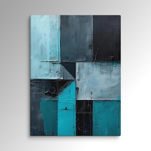 May include: Abstract wall art with a geometric design in blues, greys, and black. The artwork is made up of textured rectangular and square shapes, creating a modern, artistic look. The colour scheme includes shades of teal, light blue, and charcoal.