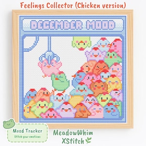 May include: A cross-stitch pattern titled Feelings Collector Chicken version featuring a claw machine filled with colorful pixelated chickens. The top banner reads DECEMBER MOOD in light blue letters. The design is framed in a light wood frame.