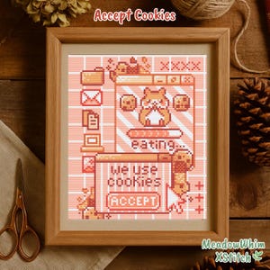 Peut inclure: Une broderie au point de croix encadrée avec un design pixélisé dans les tons pêche et marron. L'œuvre représente un hamster mangeant des cookies sur un écran d'ordinateur, avec le texte "Accept Cookies" et "We use cookies (Accept)".