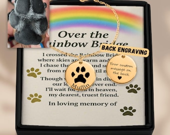 May include: A gold-colored memorial bracelet with a paw print pendant and the name "Muffin". The bracelet is displayed in a black box with text that reads "Over the Rainbow Bridge". A paw print is visible in the image.