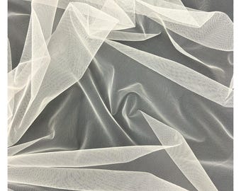 May include: Close-up of a sheer, off-white fabric with a delicate mesh texture. The fabric is draped and folded, creating shadows and highlights. The material appears lightweight and airy, suitable for various craft projects.