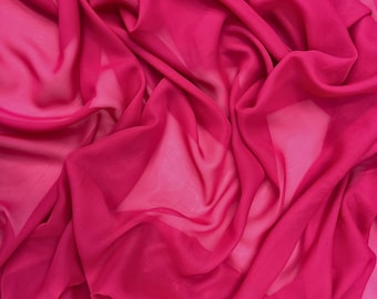 May include: A close-up shot of a vibrant fuchsia fabric with a flowing, translucent quality. The material is draped in soft folds, creating shadows and highlights that emphasize its texture and color. The fabric appears lightweight and airy.
