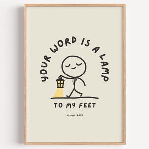 May include: A framed print with a light beige background. The artwork features a stick figure holding a lantern, with the text "Your word is a lamp to my feet" in black. The bottom of the print includes the text "Psalm 119:105".