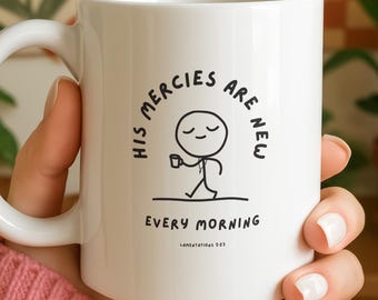 May include: White ceramic mug with a curved handle. The mug features a black and white illustration of a stick figure holding a cup, with the text "HIS MERCIES ARE NEW EVERY MORNING" and "Lamentations 3:23".