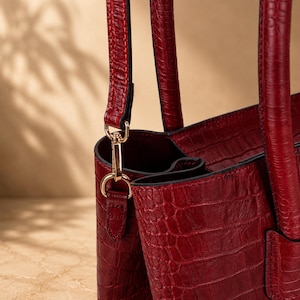 Croco embossed calf leather texture and gold hardware close-up detail