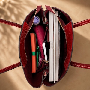 Luxury work tote bag holding phone wallet and daily essentials