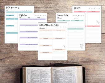 May include: A collection of printable Bible study pages with various layouts, including "Bible Summary," "Reflection," and "Biblical Character Profile." The pages are arranged on a wooden surface with an open Bible at the bottom. The pages have pastel color accents.
