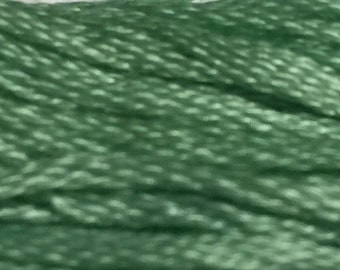 May include: A close-up of a bundle of soft, green embroidery floss.