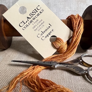 May include: A spool of Colonial Copper embroidery floss, 5 yards, 100% cotton, not colorfast, on a wooden spool with a label that reads "CLASSIC COLORWORKS CCT-170".