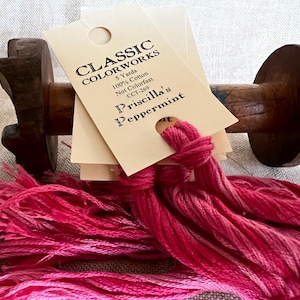 May include: A spool of pink embroidery floss with a tag that reads "Classic Colorworks 5 Yards 100% Cotton Not Colorfast CCT-269 Priscilla's Peppermint"