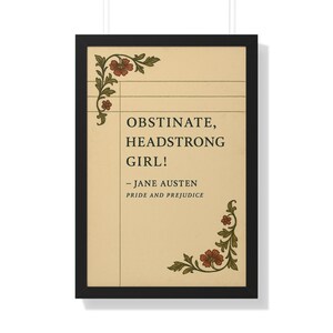 May include: Framed print featuring the quote "Obstinate, Headstrong Girl!" from Jane Austen's Pride and Prejudice. The text is in black on a cream-colored background, with floral corner accents in red and green.